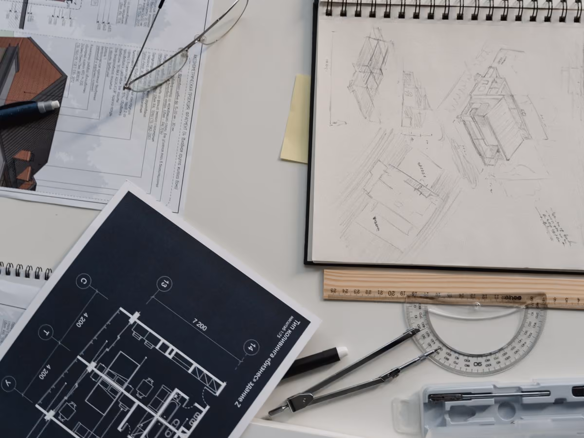 Person reviewing a blueprint on a laptop