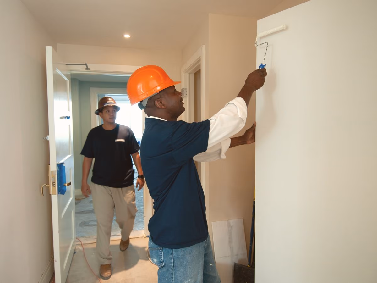 Workers painting interior walls