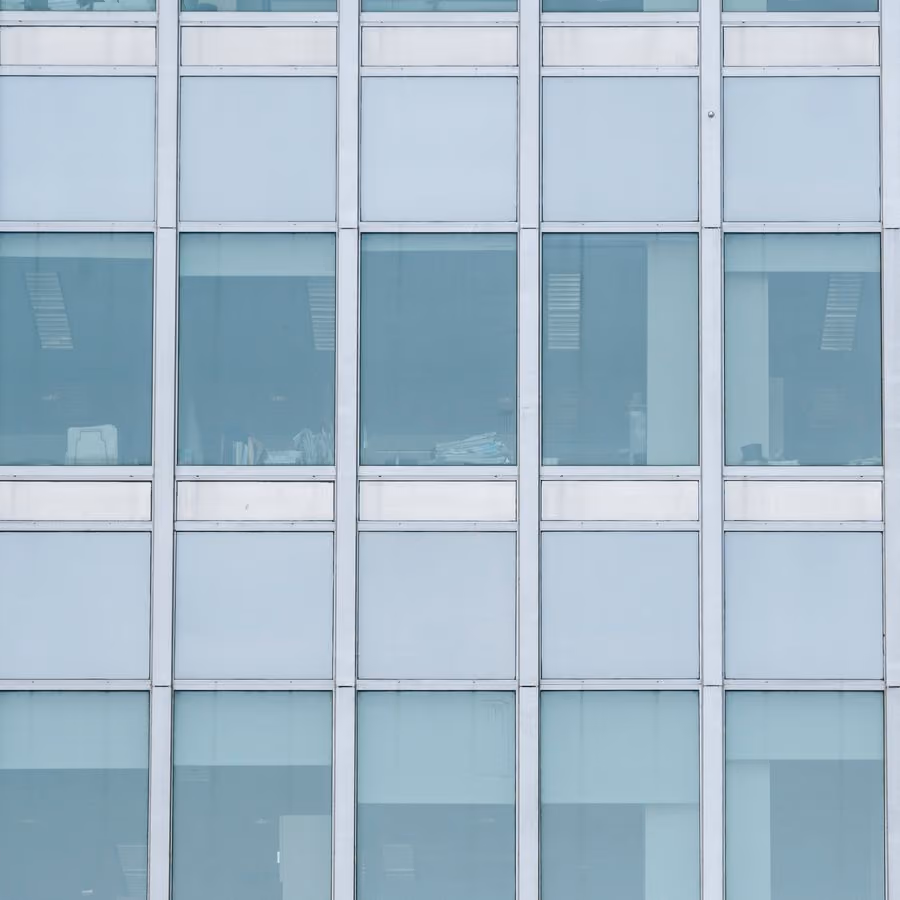 Glass-walled office building facade (placeholder photo)