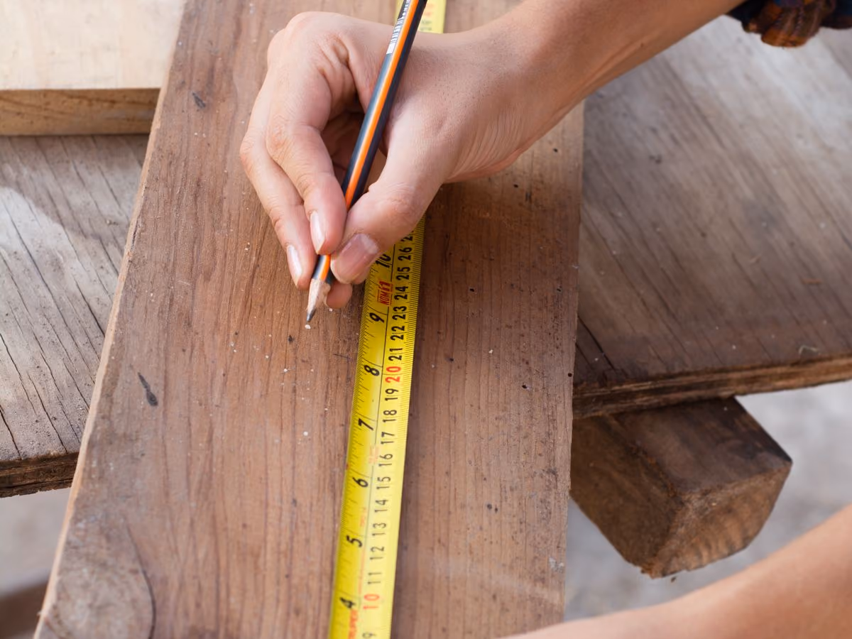 Measuring wood with a ruler during fabrication
