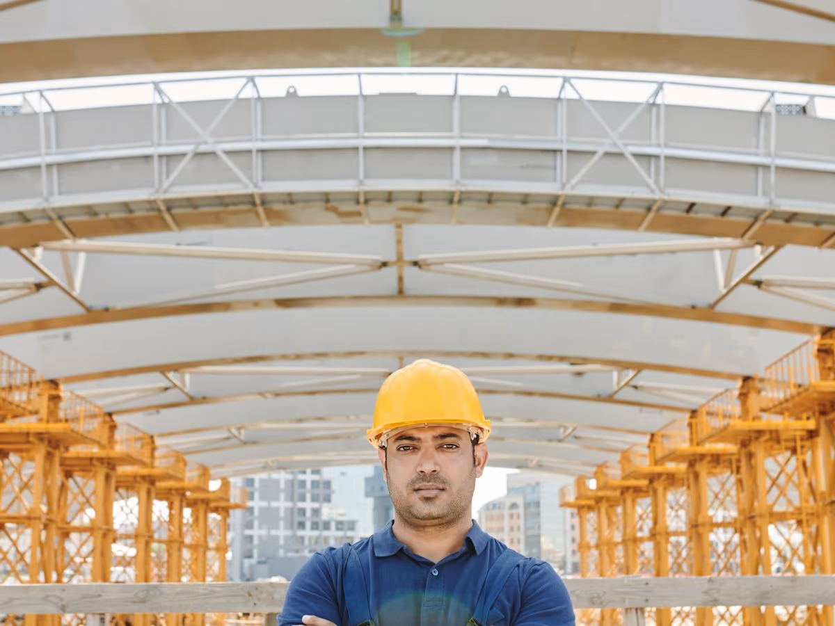 Supervisor standing under structural framing on site
